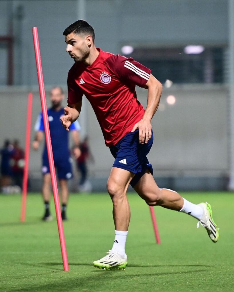 Photo by Olympiacos FC in Προπονητικό Κέντρο Ρέντη with @geo masou. May be an image of 2 people people playing football people playing soccer cleats sports equipment stadium and text